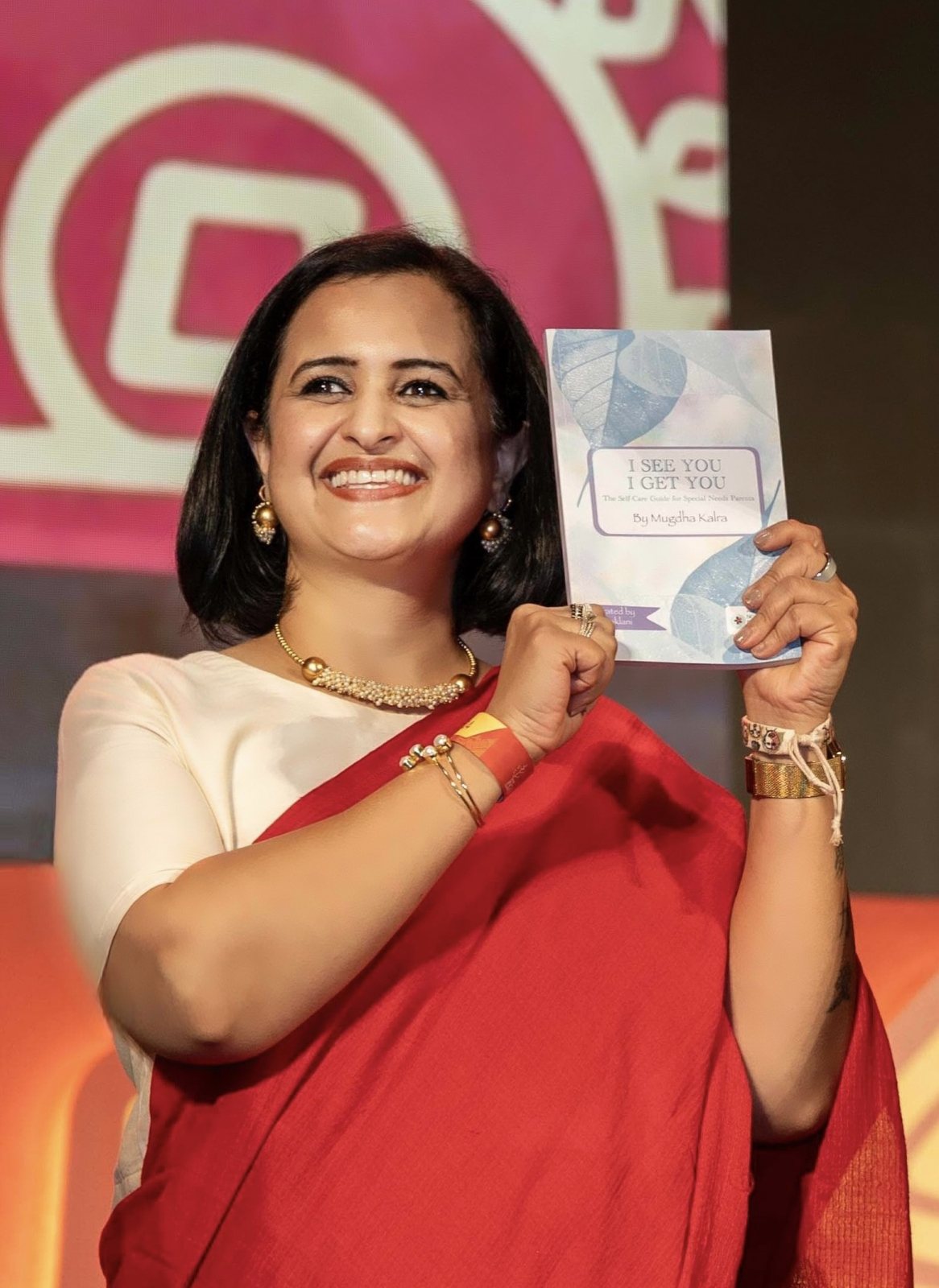 Mugdha Kalra holding her book, I See You I Get You